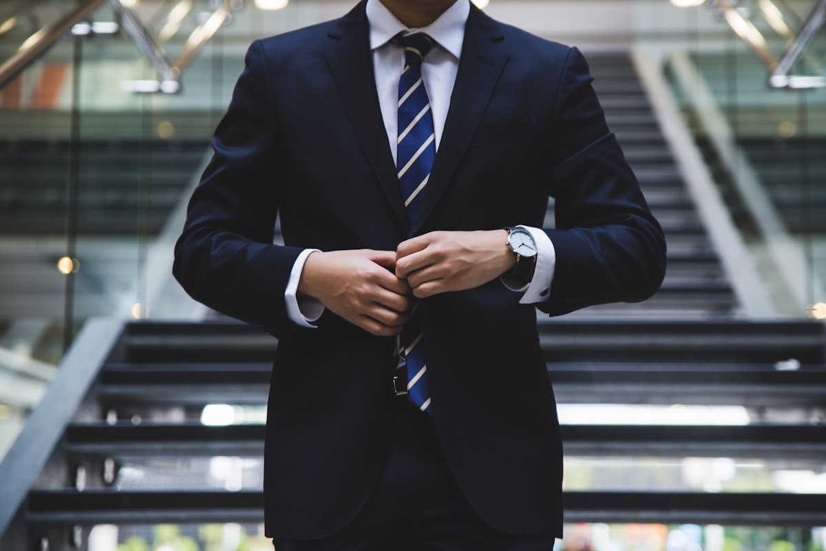 An executive in a tailored suit in a corporate office