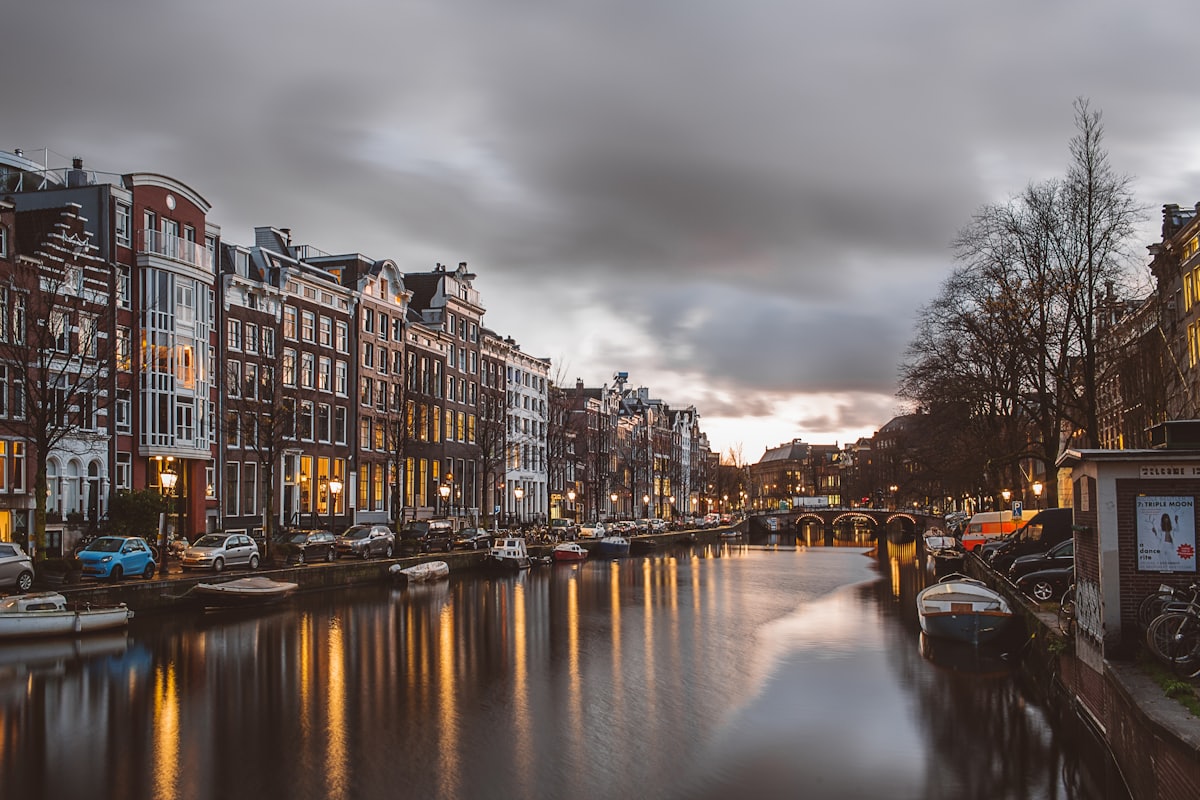 Canal houses along an Amsterdam waterway at dusk