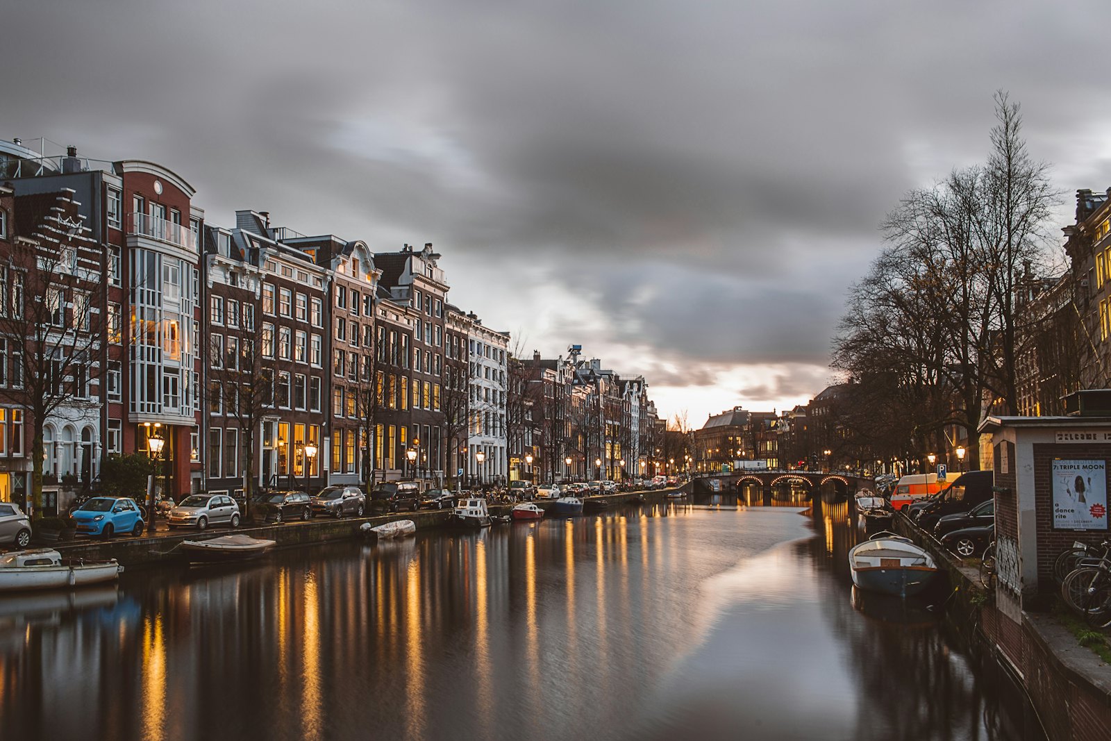 Canal houses along an Amsterdam waterway at dusk